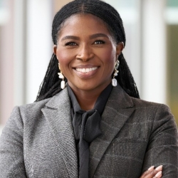 Olivia Jefferson, pictured smiling in a gray sport coat arms folded